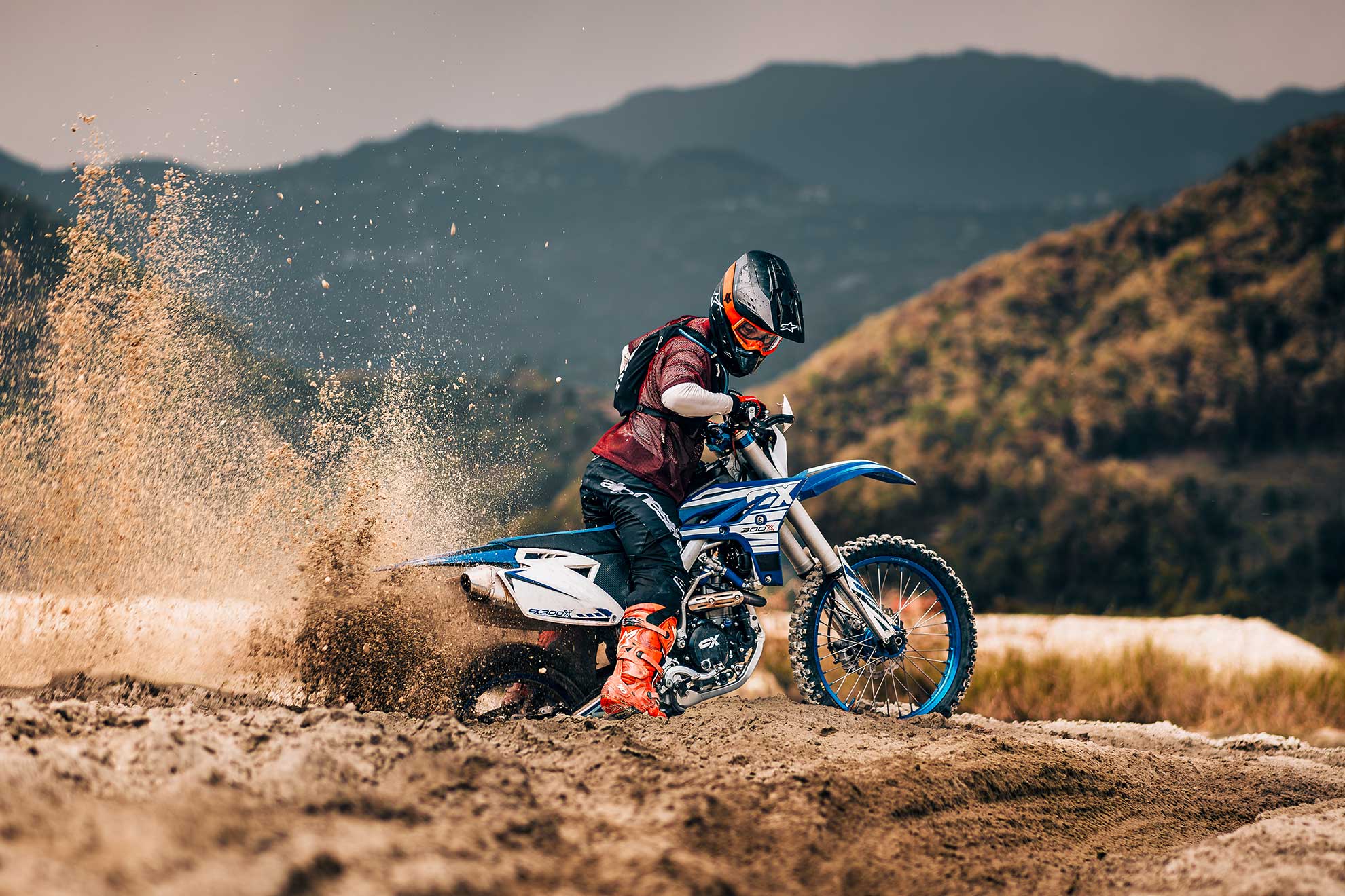 CX off-road motorcycle riding on a dirt trail